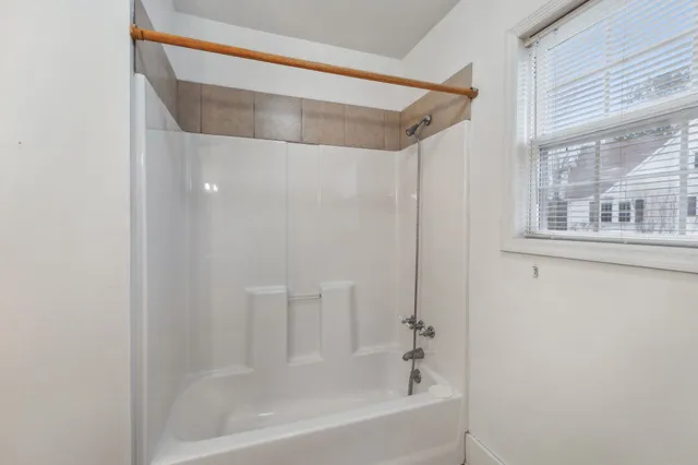 a bathroom with a bathtub and a shower