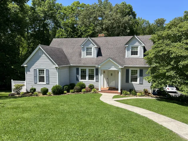 a aerial view of a house with a yard patio and green space