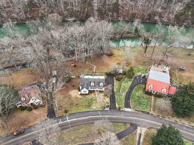 a view of a lake in between the two trees