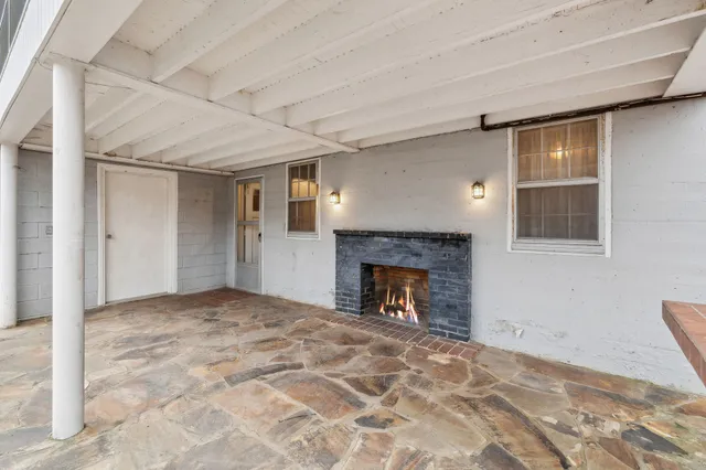 a view of a terrace with chairs and a stove