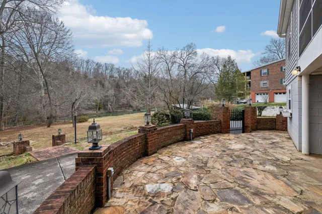 an aerial view of a house with a yard and lake view