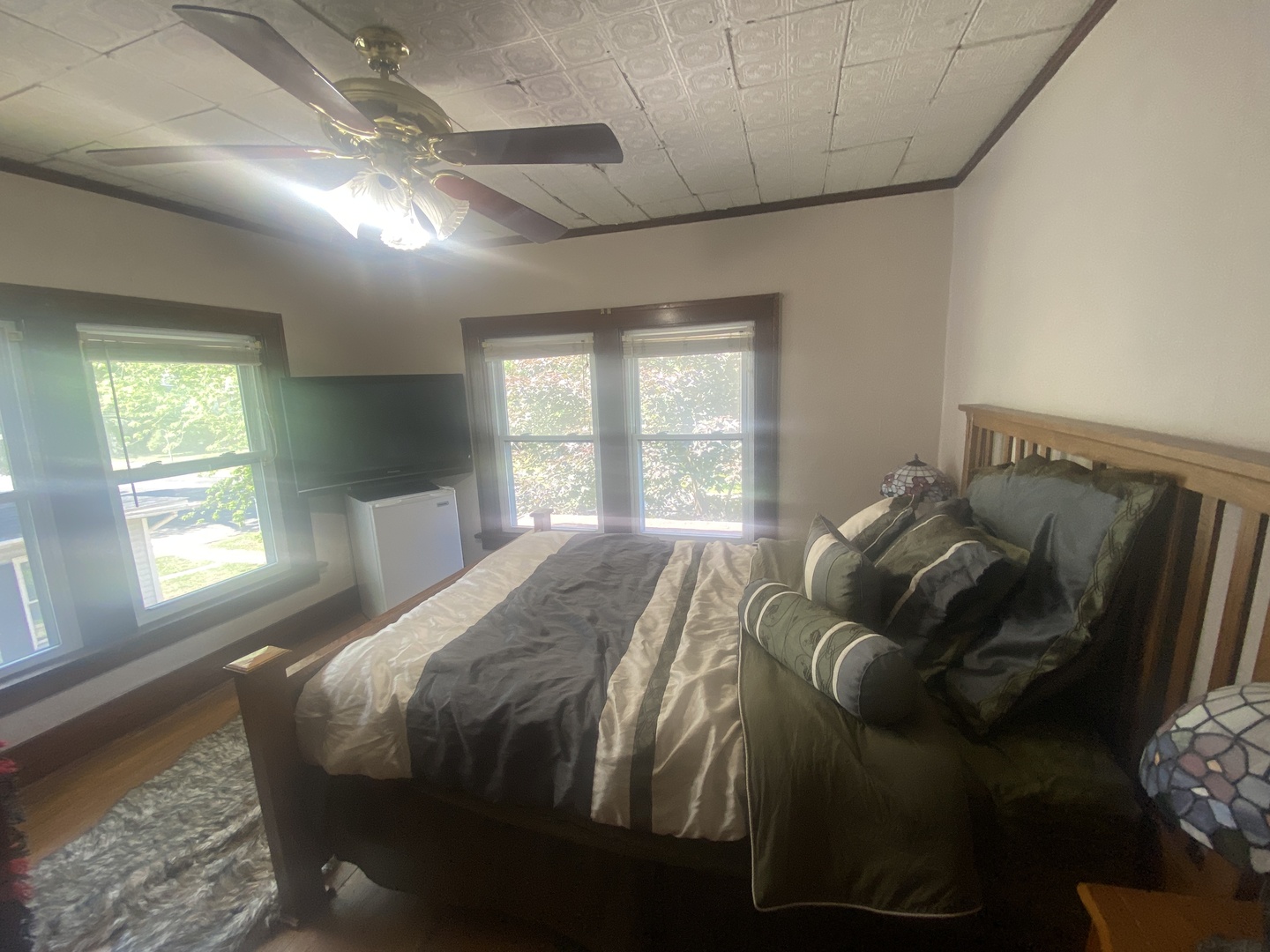 540 North 7th Street DeKalb, IL 60115 - Photo 11 of 14 a bed sitting in a bedroom next to a window and a chandelier