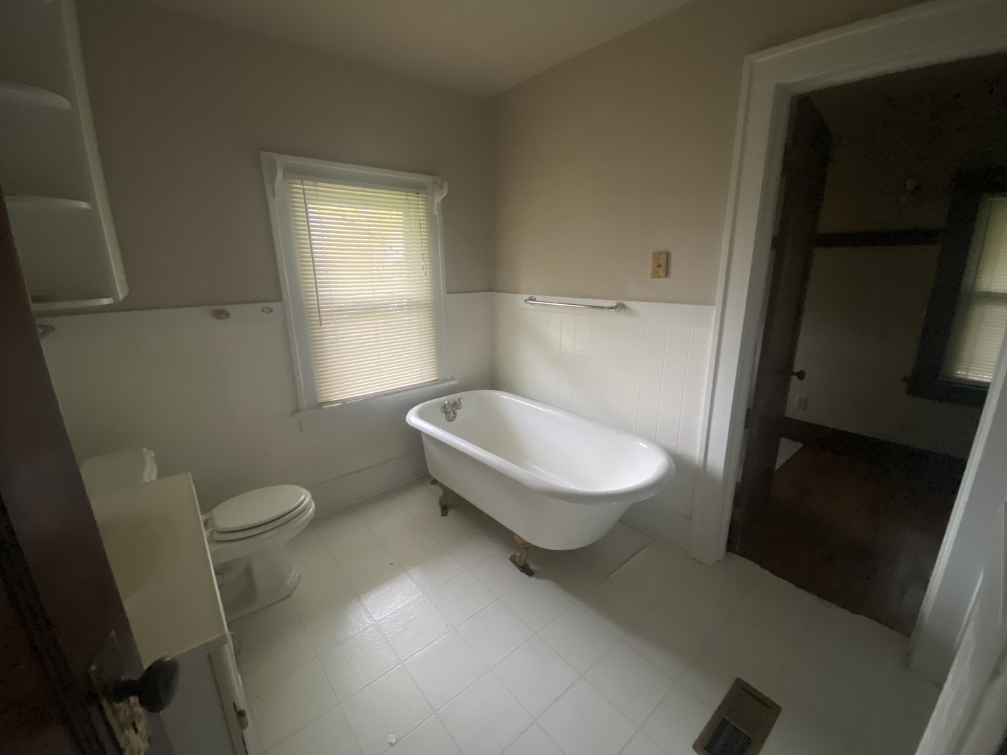 540 North 7th Street DeKalb, IL 60115 - Photo 14 of 14 a bed sitting in a bedroom next to a window and a chandelier