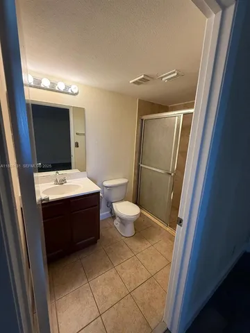 a bathroom with a sink mirror and toilet