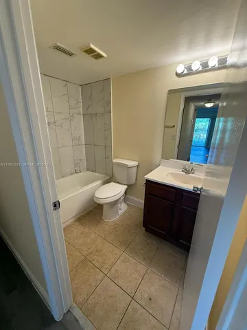 a bathroom with a bathtub a sink and a mirror