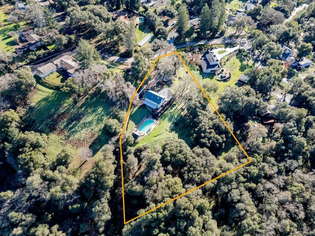 a view of a hallway with wooden floor and entryway