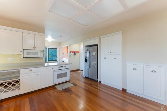 a view of washer and dryer with kitchen in the background