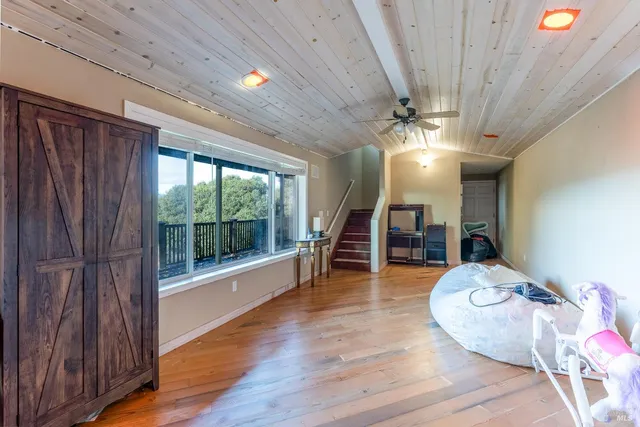 a work room with furniture and a ceiling fan