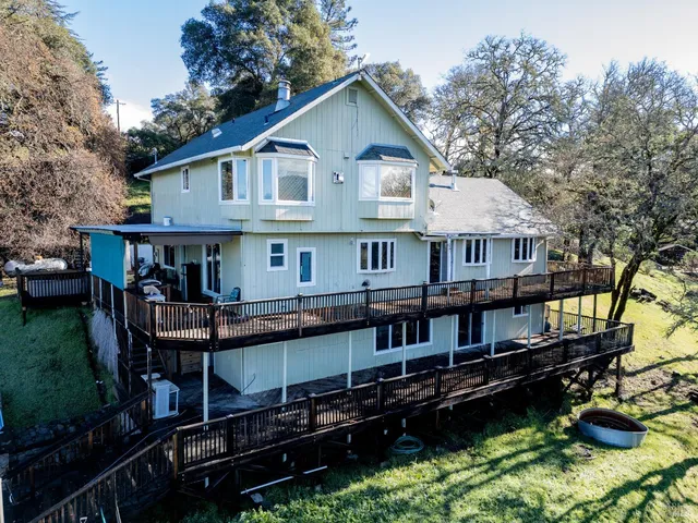 a front view of a house with yard porch and sitting area