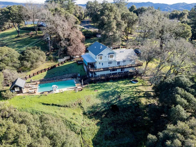 a aerial view of a house with a yard
