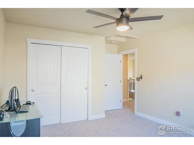 a picture of a room with a ceiling fan and a window