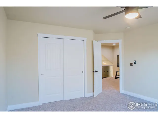 a view of a hallway with wooden floor and entryway