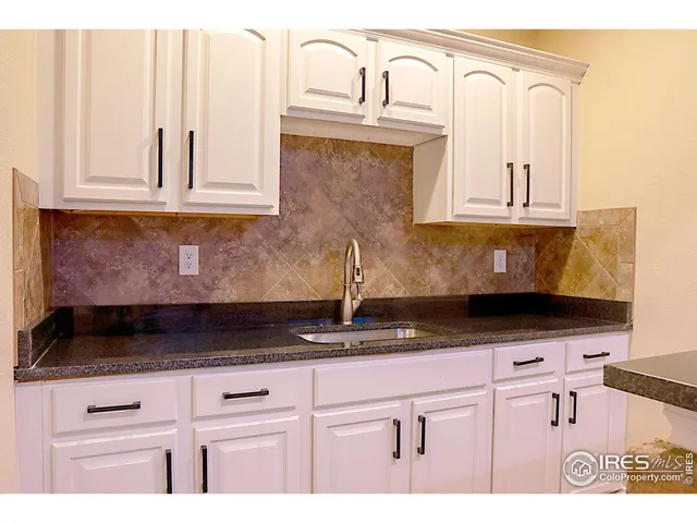 a view of an empty room with a fireplace and dining room