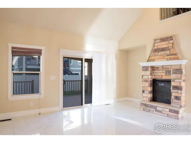 a black and white photo of a livingroom with an entryway and fireplace