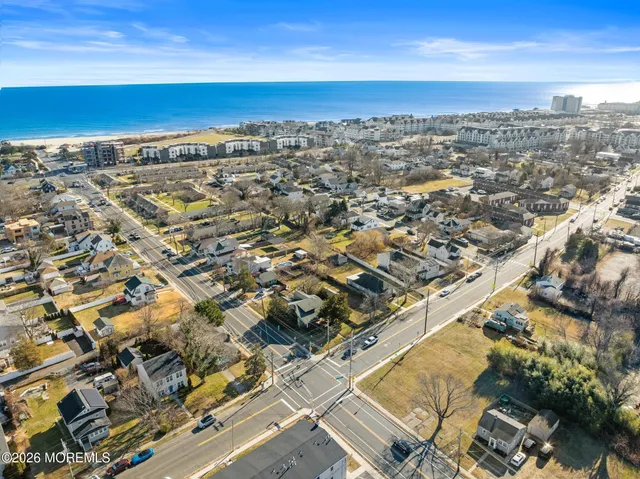 an aerial view of a city with ocean view