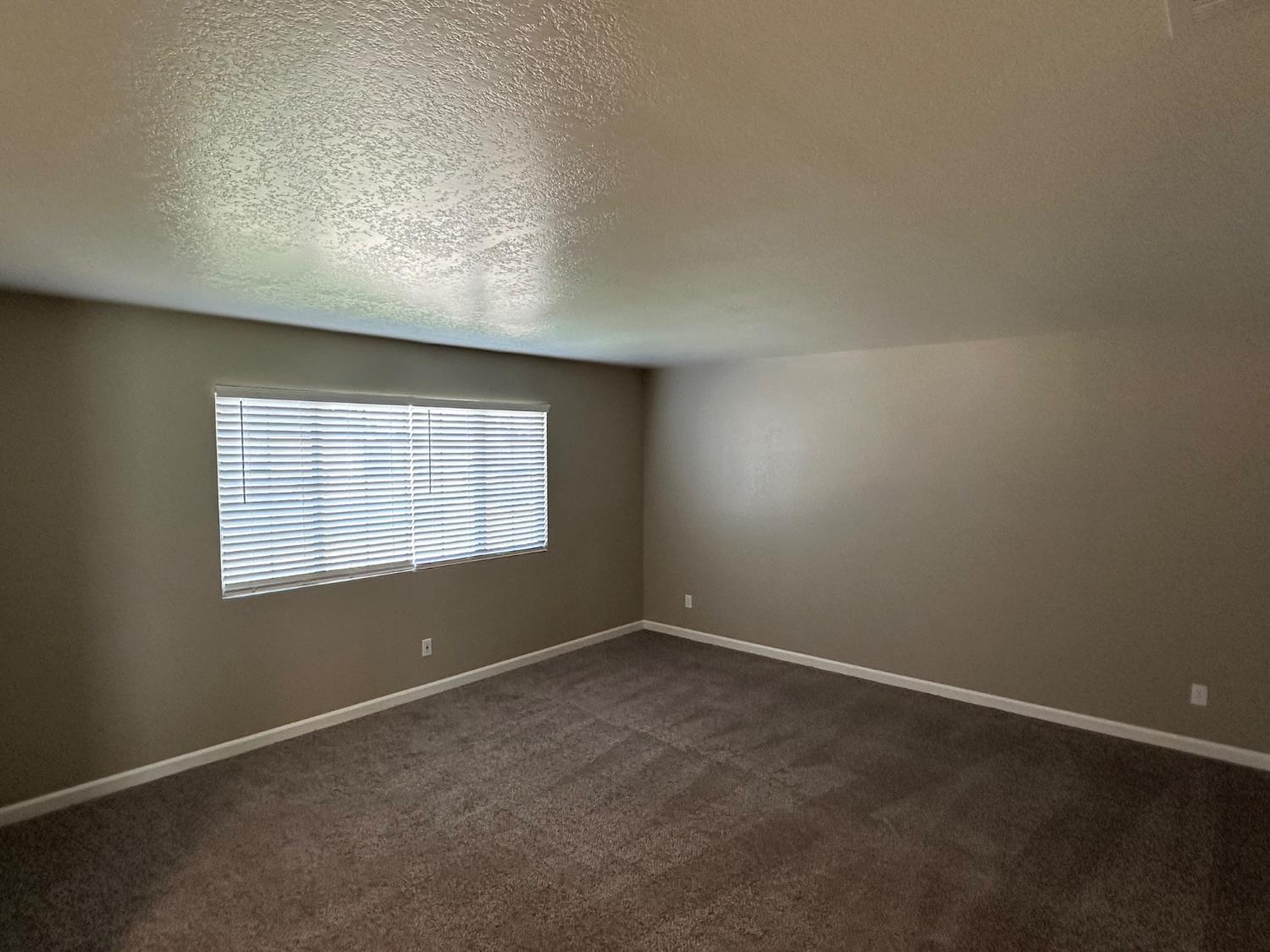 924 Kingery Drive Ripon, CA 95366 - Photo 18 of 18 an empty room with a empty space and windows