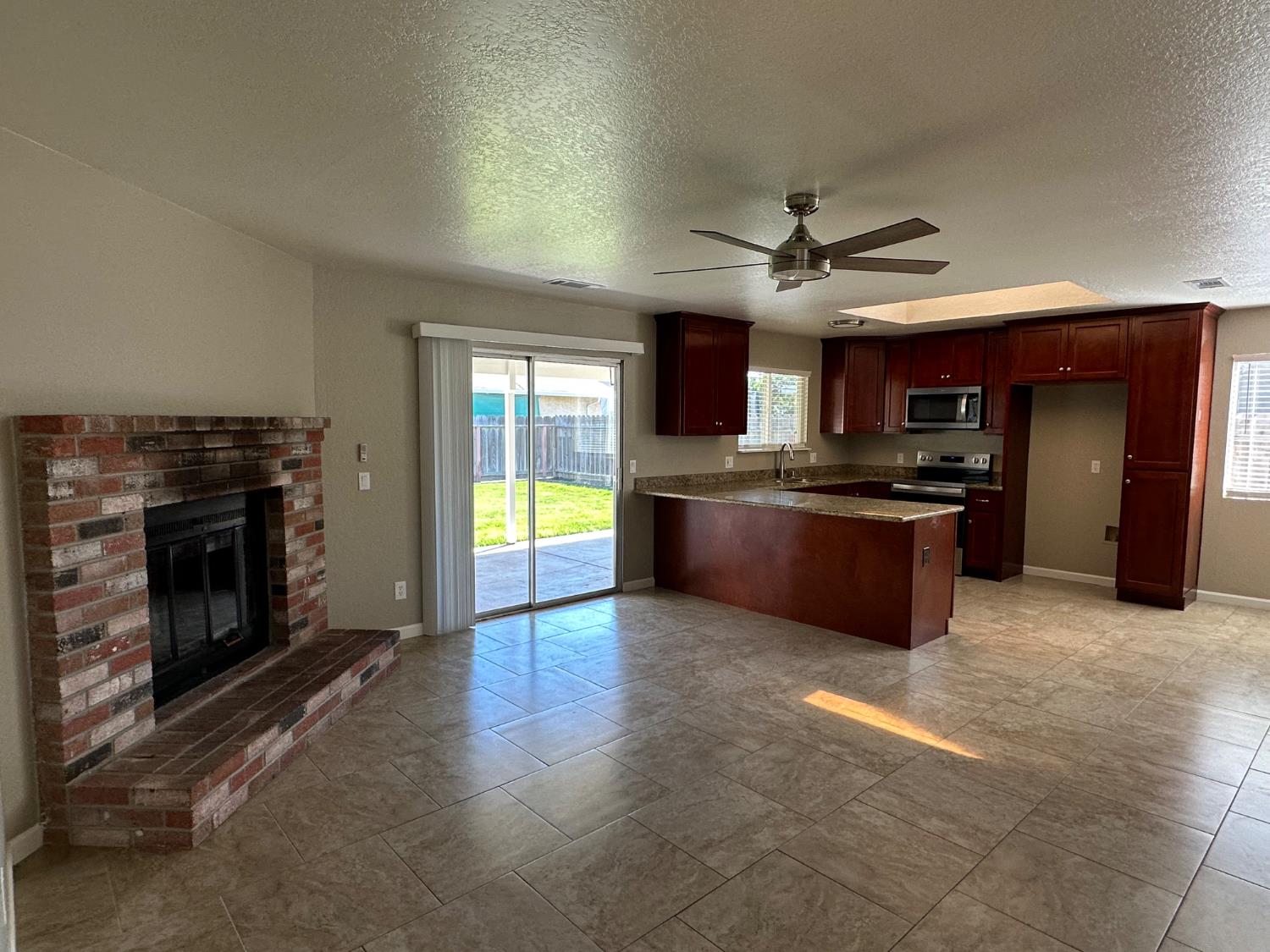 924 Kingery Drive Ripon, CA 95366 - Photo 3 of 18 a large kitchen with stainless steel appliances granite countertop a stove top oven a sink and a refrigerator