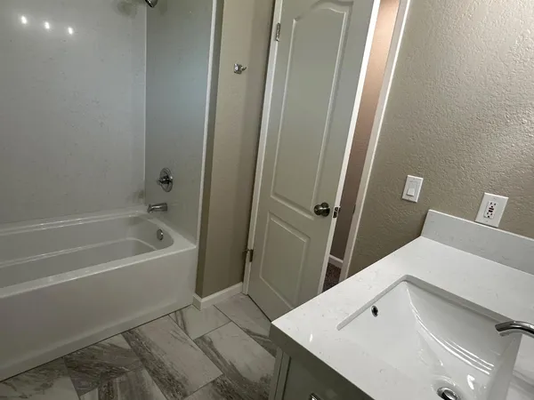a bathroom with a bathtub and shower