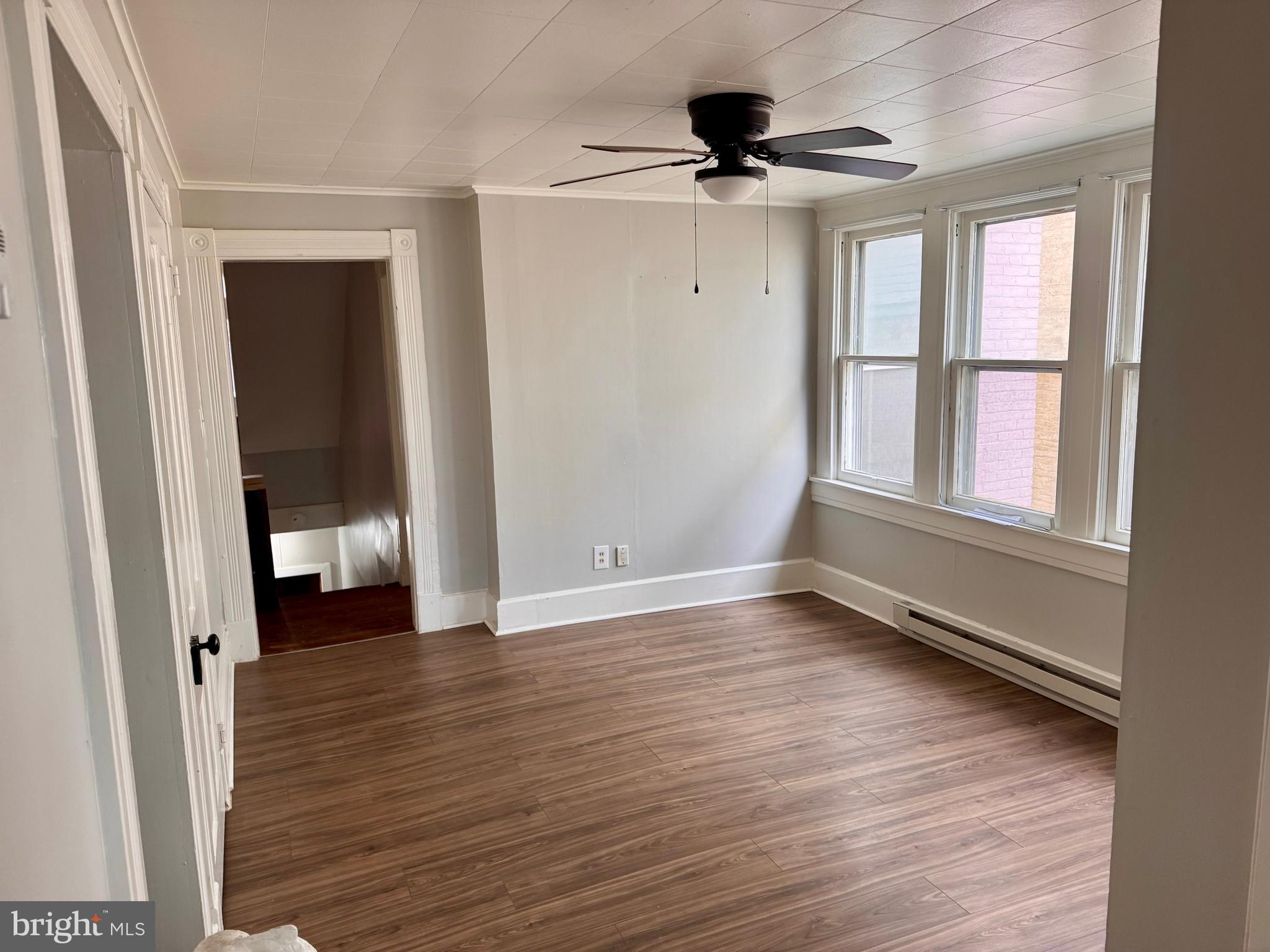 110 West Main Street Waynesboro, PA 17268 - Photo 3 of 10 wooden floor in an empty room with a window