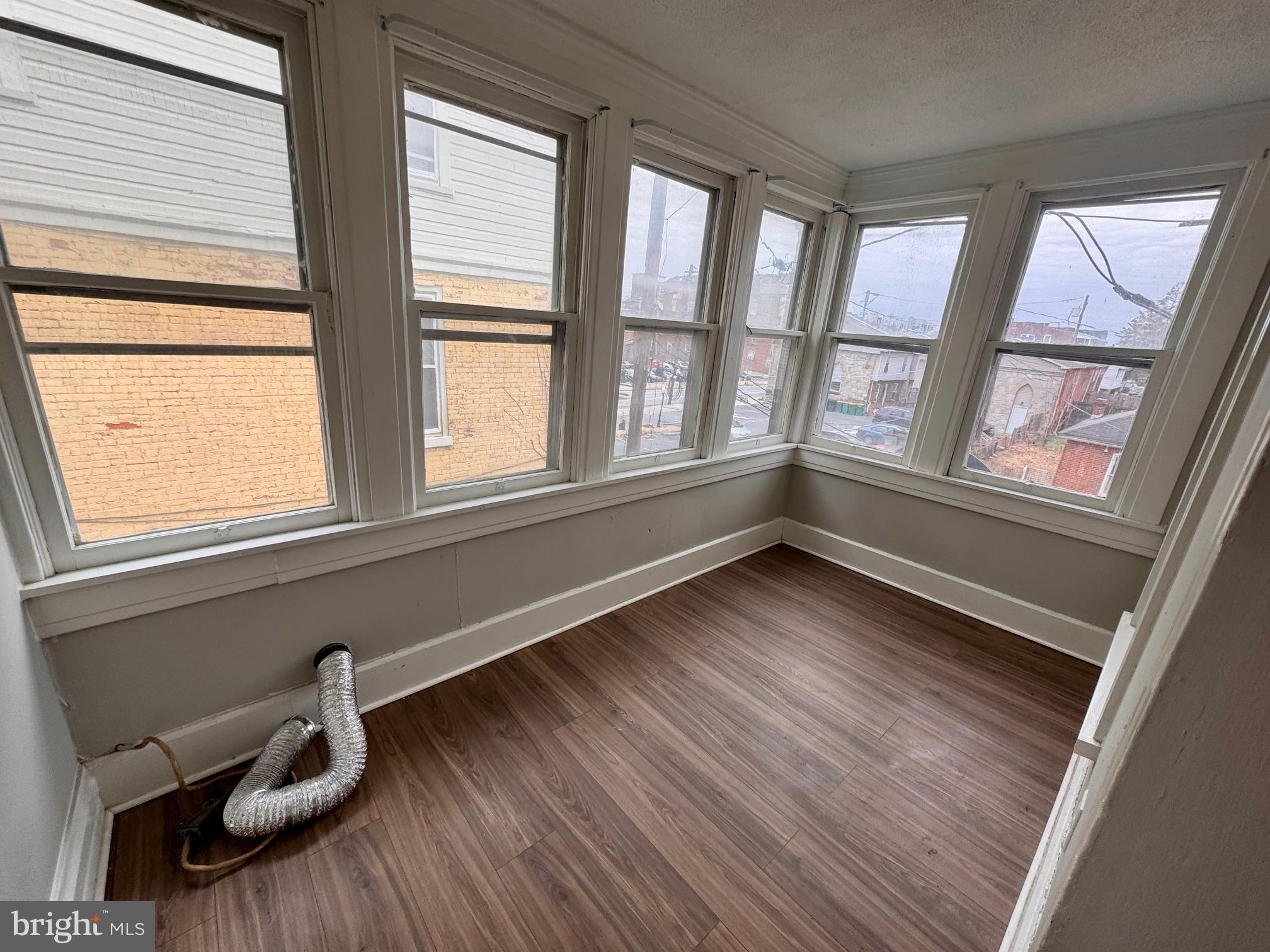 110 West Main Street Waynesboro, PA 17268 - Photo 4 of 10 a view of an empty room with wooden floor and a window