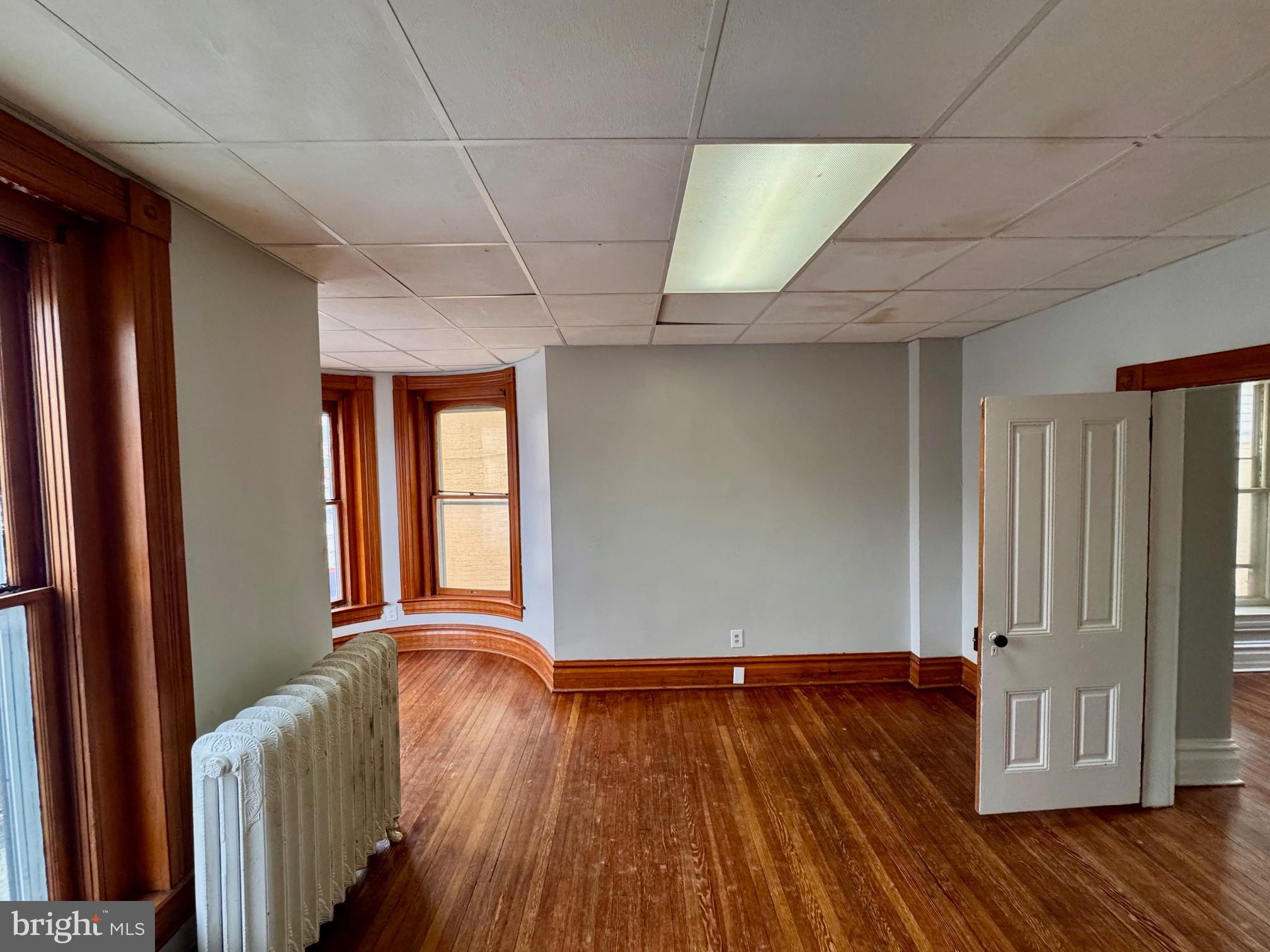 110 West Main Street Waynesboro, PA 17268 - Photo 8 of 10 wooden floor in an empty room with a window