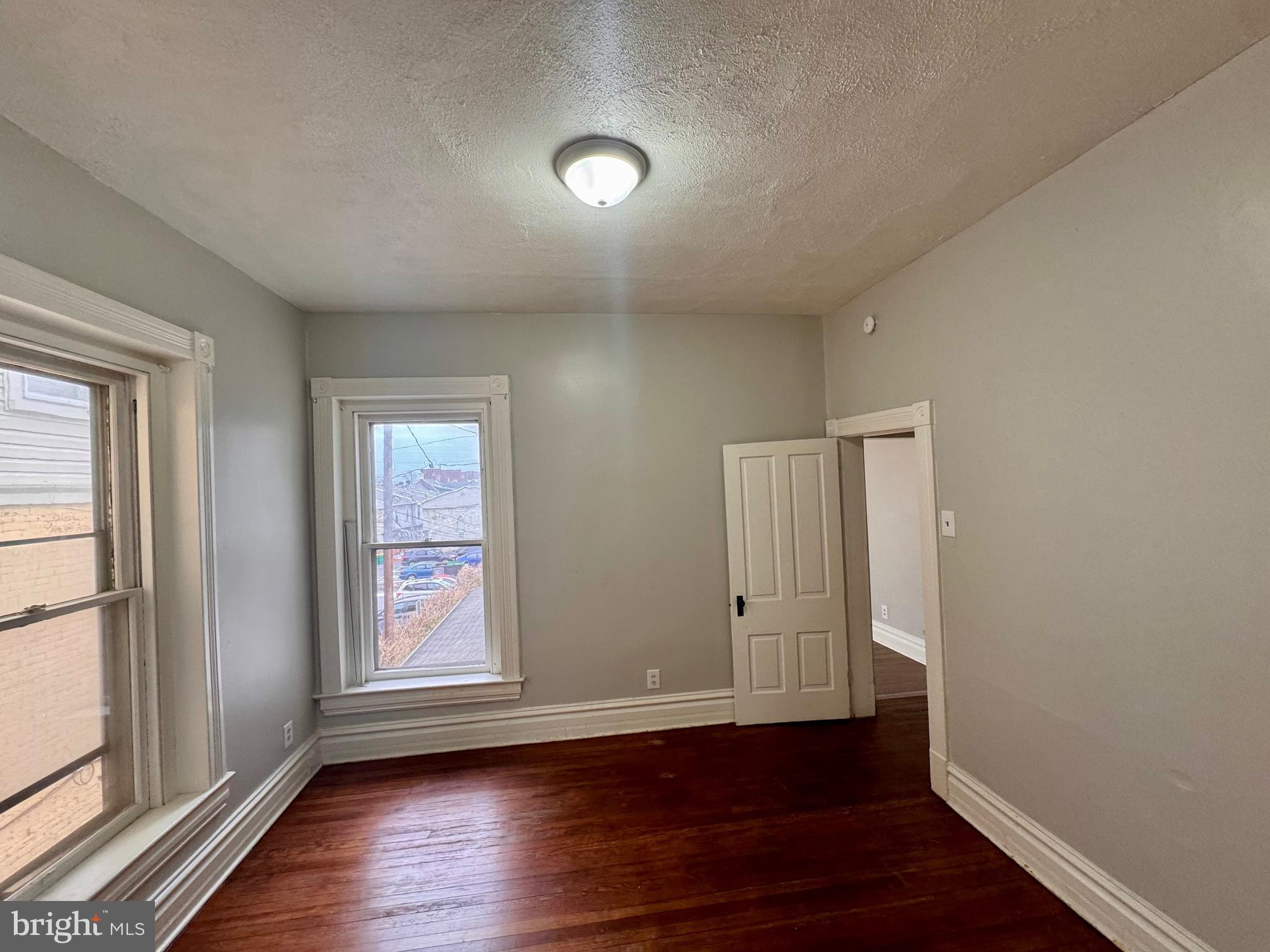 110 West Main Street Waynesboro, PA 17268 - Photo 9 of 10 an empty room with wooden floor and windows