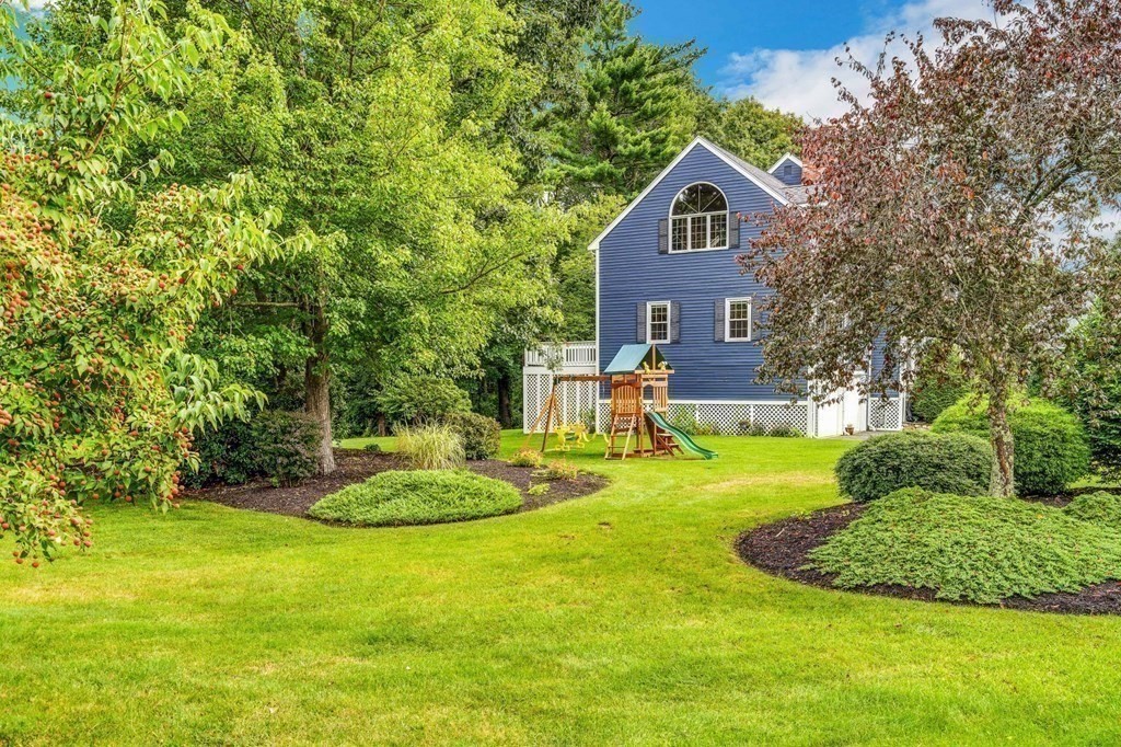 8 Liberty Road Medfield, MA 02052 - Photo 24 of 29 a front view of a house with a yard and trees