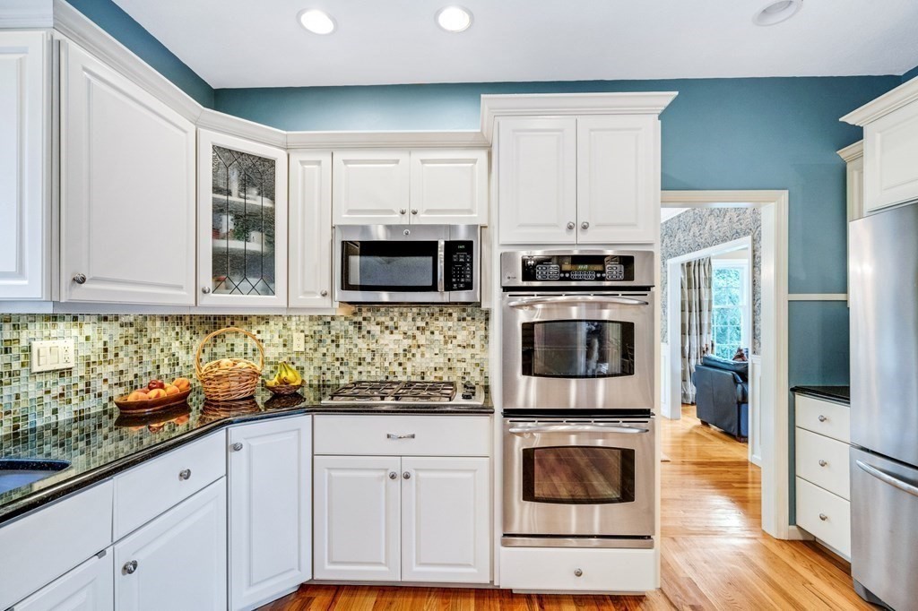 8 Liberty Road Medfield, MA 02052 - Photo 7 of 29 a kitchen with stainless steel appliances granite countertop a stove a microwave and a refrigerator