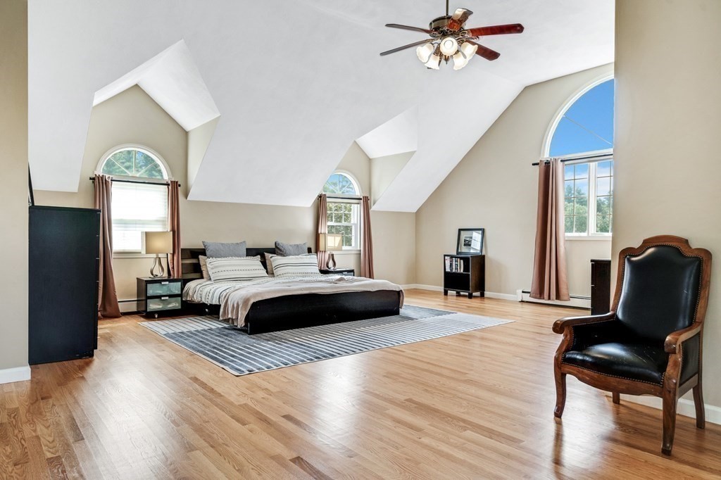 8 Liberty Road Medfield, MA 02052 - Photo 10 of 29 a bedroom with a bed and wooden floor