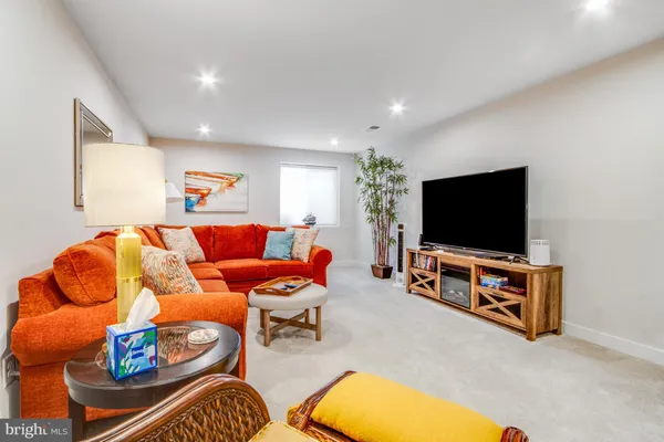 a living room with furniture and a lamp