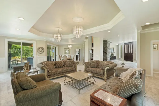 a living room with furniture fireplace and a large window