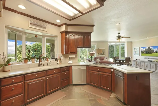 a bathroom with a granite countertop sink a mirror a toilet and a shower