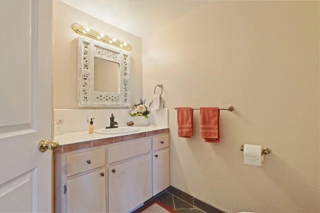 a spacious bedroom with a bed and a chandelier