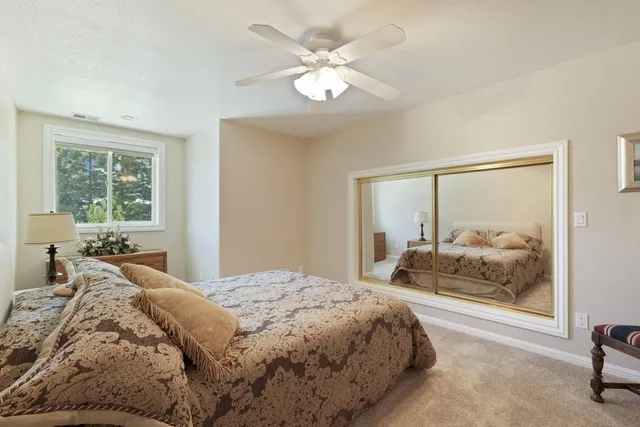 an aerial view of a house with a garden and a lake view