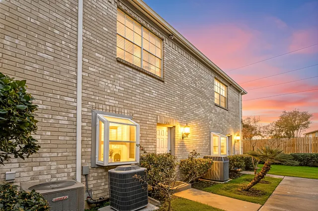 a view of a brick house with many windows