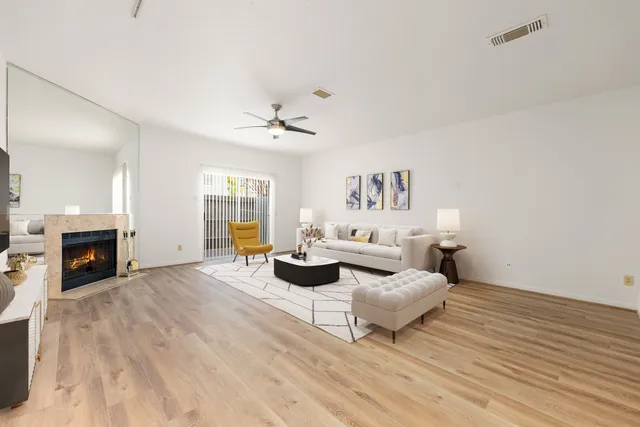 a living room with furniture and fireplace