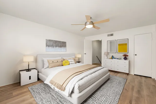 a bedroom with a bed and wooden floor