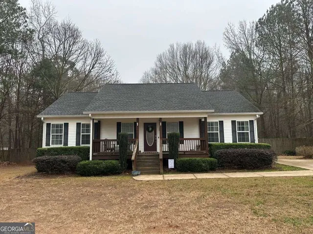 a front view of a house with yard and green space
