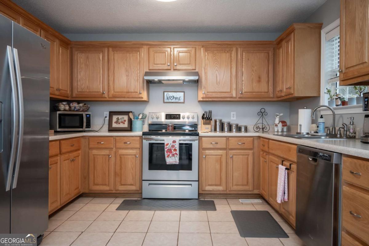 199 Brickyard Road Comer, GA 30629 - Photo 13 of 43 a kitchen with stainless steel appliances granite countertop a refrigerator sink and cabinets
