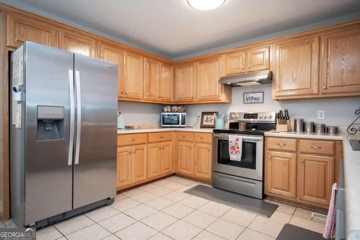 199 Brickyard Road Comer, GA 30629 - Photo 14 of 43 a kitchen with a refrigerator sink and cabinets