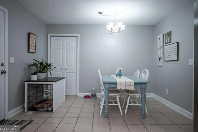 a view of a dining room with furniture and chandelier