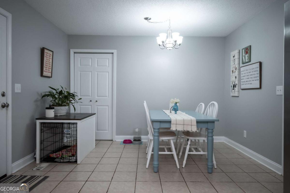 199 Brickyard Road Comer, GA 30629 - Photo 17 of 43 a view of a dining room with furniture and chandelier