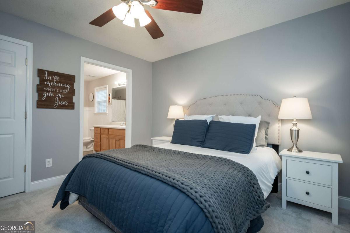 199 Brickyard Road Comer, GA 30629 - Photo 19 of 43 a bedroom with a bed and a lamp