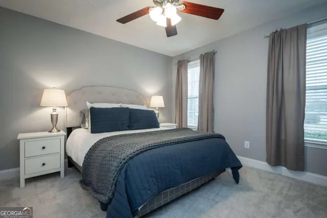 a bedroom with a large bed and a chandelier