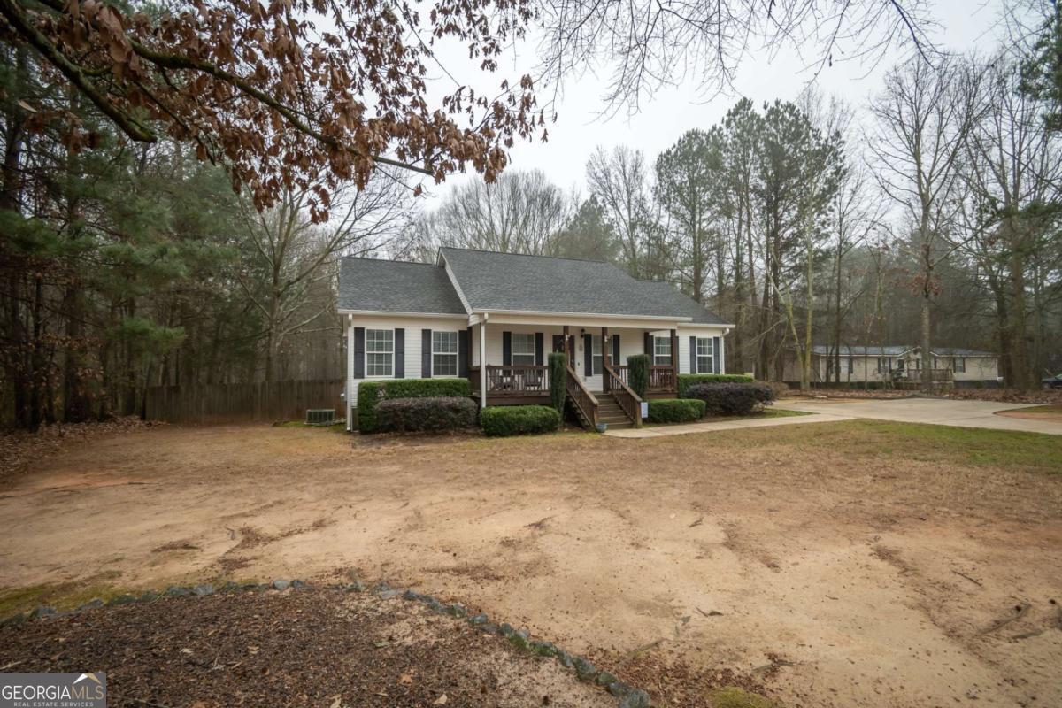 199 Brickyard Road Comer, GA 30629 - Photo 2 of 43 a front view of a house with a yard covered with snow and trees