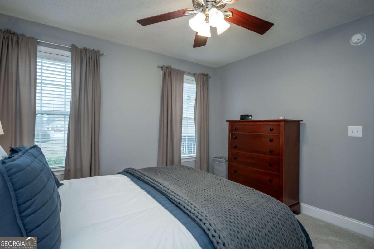 199 Brickyard Road Comer, GA 30629 - Photo 21 of 43 a bedroom with a bed and a chandelier