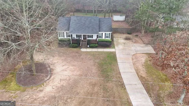 a view of a brick house with a yard