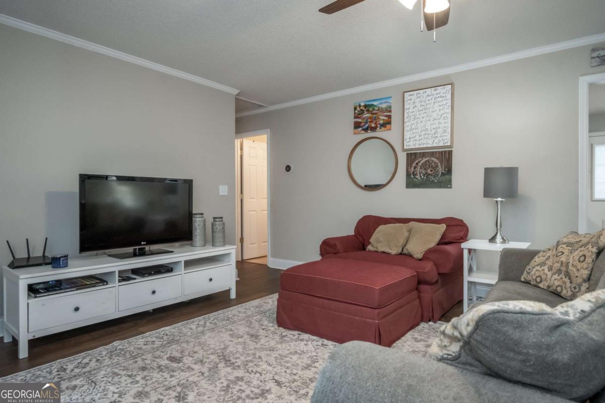 199 Brickyard Road Comer, GA 30629 - Photo 6 of 43 a living room with furniture and a flat screen tv