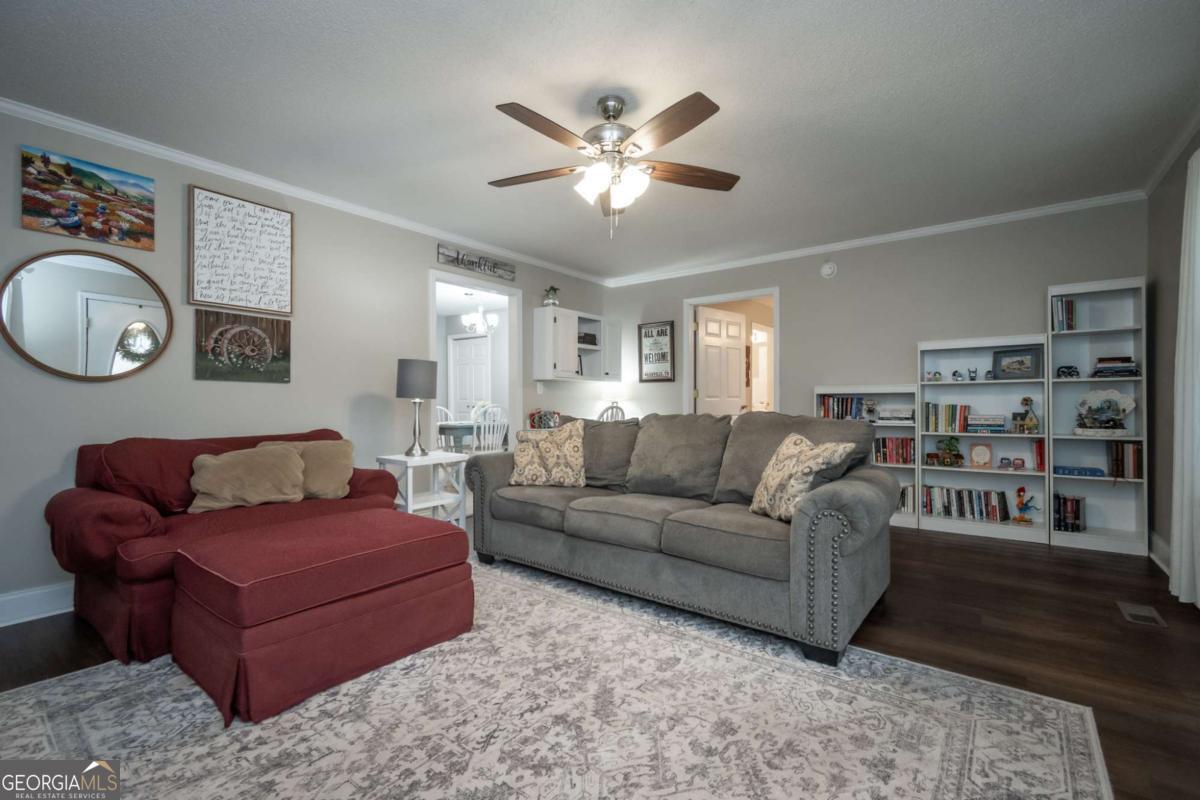 199 Brickyard Road Comer, GA 30629 - Photo 7 of 43 a living room with furniture and a clock