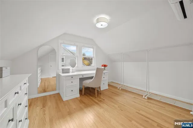 a room with a wooden floor and white walls